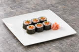 A2837 white flat square plate with maki rolls on a restaurant table.