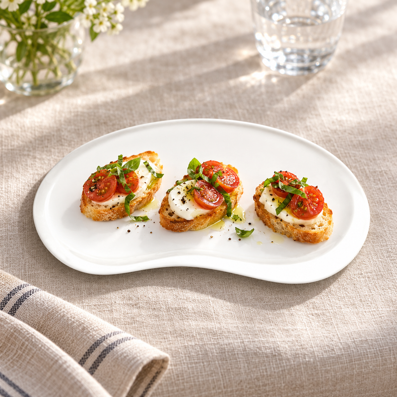 A391-02 white bean-shaped plate with tomato and mozzarella crostini