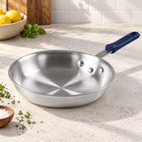 14" Natural-Finish 3003 Aluminum Fry Pan with Silicone Handle on a restaurant preparation counter