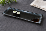 AS212-BK black ceramic divided plate with two cucumber maki and soy sauce in its corner well, serving suggestion
