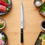 IKKAKU Bessaku 270 mm yanagiba in a light kitchen preparation setting