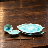 BH22-B blue leaf set with two stacked plates, two small dishes and two chopstick pairs, on a wooden table