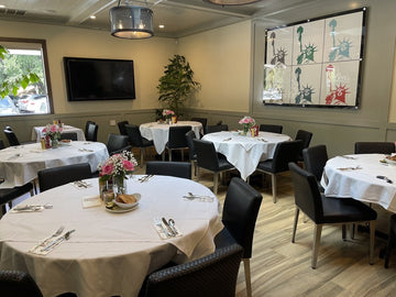 Black Upholstered Restaurant Chair with Stainless Steel Legs in a restaurant setting; other furniture is illustrative
