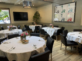 Black Upholstered Restaurant Chair with Stainless Steel Legs in a restaurant setting; other furniture is illustrative