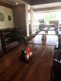 Natural black walnut butcher block tabletops in restaurant setting; bases and other furniture not included; dimensions vary by size