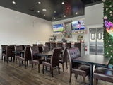 Brown Upholstered Restaurant Chair with Walnut-Finish Metal Frame in a restaurant setting; other furniture is illustrative
