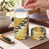 Silver and gold botanical tea canister with outer lid removed before tea preparation