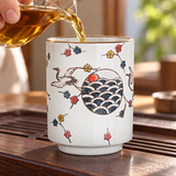 FDC1 crane and wave ceramic teacup in a tea pouring setting; contextual accessories not included.