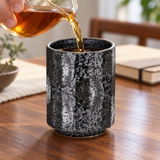 KA70-5 dark mottled ceramic teacup in a tea pouring setting; contextual accessories not included.