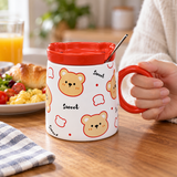 White bear mug with red lid and spoon in a breakfast setting. Contextual accessories are not included.