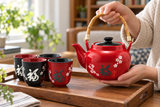 TPS4-333 red-and-black tea set in a teapot handling setting; contextual accessories not included.