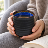 AS70-SP ribbed black and cobalt teacup held during reading
