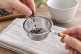 6592-70 tea-strainer basket held upright while loose tea is added; tea and accessories not included.