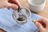 6592-75 open tea-strainer basket held while loose tea is added; tea and cup not included.
