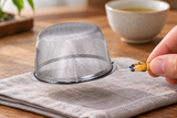 6592-80 stainless-steel tea strainer held inverted by its short bamboo grip; contextual accessories not included.
