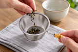 6592-80 open tea-strainer basket held while dry loose tea is added; tea and cup not included.
