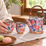 H2-19-2 floral tea set with one cup held for tea