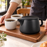 Black coffee dripper pot on a serving tray with coffee cups; cups and other props not included.
