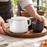 White coffee dripper pot on a serving tray with coffee cups; cups and other props not included.