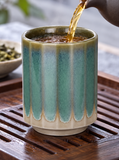 Tea being poured into the teal drip ribbed teacup