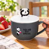 Charcoal panda mug with white panda lid at a strawberry breakfast setting