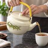 WH-11-6 bamboo-design teapot during pouring; cups, tray and other scene accessories are not included.
