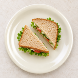 Ivory narrow-rim dinner plate with sandwich halves