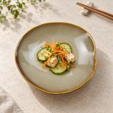DJ-PL21-BR cream-and-brown deep round plate with cucumber and tofu salad on a pale stone table