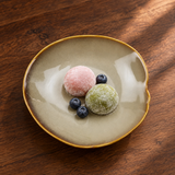 DJ-PL21-BR cream-and-brown deep round plate with mochi and blueberries on a walnut tabletop