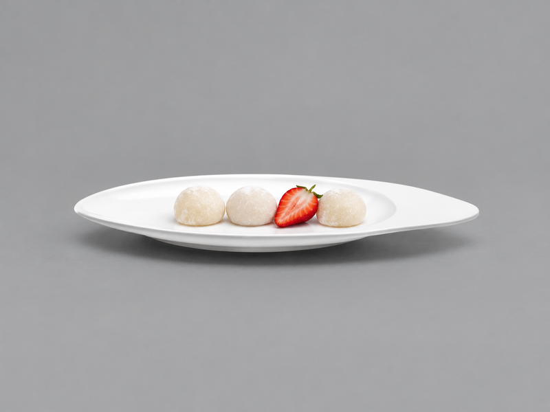 D105-05 white asymmetric oval plate with mochi and a strawberry half