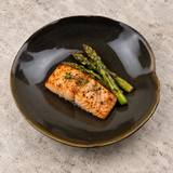 Gray-black deep ceramic plate with salmon and asparagus