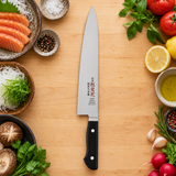 IKKAKU Donryu 210 mm gyuto in a light kitchen preparation setting