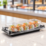 ED-30B black sushi container with sushi rolls in a pickup setting