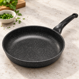 12" Durastone Marble Cast Aluminum Fry Pan on a restaurant preparation counter