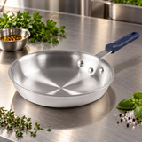 10" Natural-Finish 3003 Aluminum Fry Pan with Silicone Handle on a restaurant preparation counter