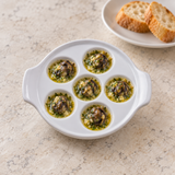 White six-well escargot dish with garlic-butter escargot portions