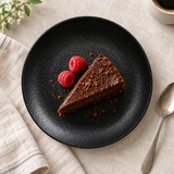 6¼″ Textured Black Porcelain Coupe Plate with an individual dessert presentation; table accessories shown separately