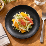 6¼″ Textured Black Porcelain Coupe Plate with a composed salad; table accessories shown separately