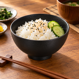 5″ Black Porcelain Round Bowl — 15 oz with steamed rice; table accessories shown separately