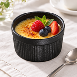 3½″ Textured Black Porcelain Ramekin — 6 oz with a custard dessert; table accessories shown separately