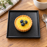 6″ Textured Black Porcelain Stackable Square Plate with an individual tart; table accessories shown separately