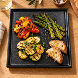 10″ Textured Black Porcelain Stackable Square Plate with a shared starter arrangement; table accessories shown separately