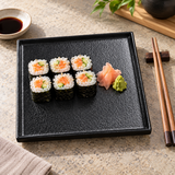 8″ Textured Black Porcelain Stackable Square Plate with a sushi presentation; table accessories shown separately