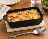 8″ × 4¼″ Textured Black Ceramic Rectangular Baking Dish — 12 oz with an individual baked gratin; table accessories shown separately