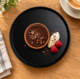 8″ Textured Black Porcelain Stackable Round Plate with an individual dessert presentation; table accessories shown separately