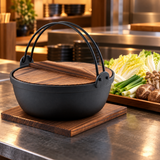 90 fl oz iron nabe pot with wood lid beside vegetables