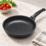 10" Durastone Marble Cast Aluminum Fry Pan on a restaurant preparation counter