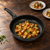 11" Durastone Marble Cast Aluminum Fry Pan with a finished meal on a restaurant counter