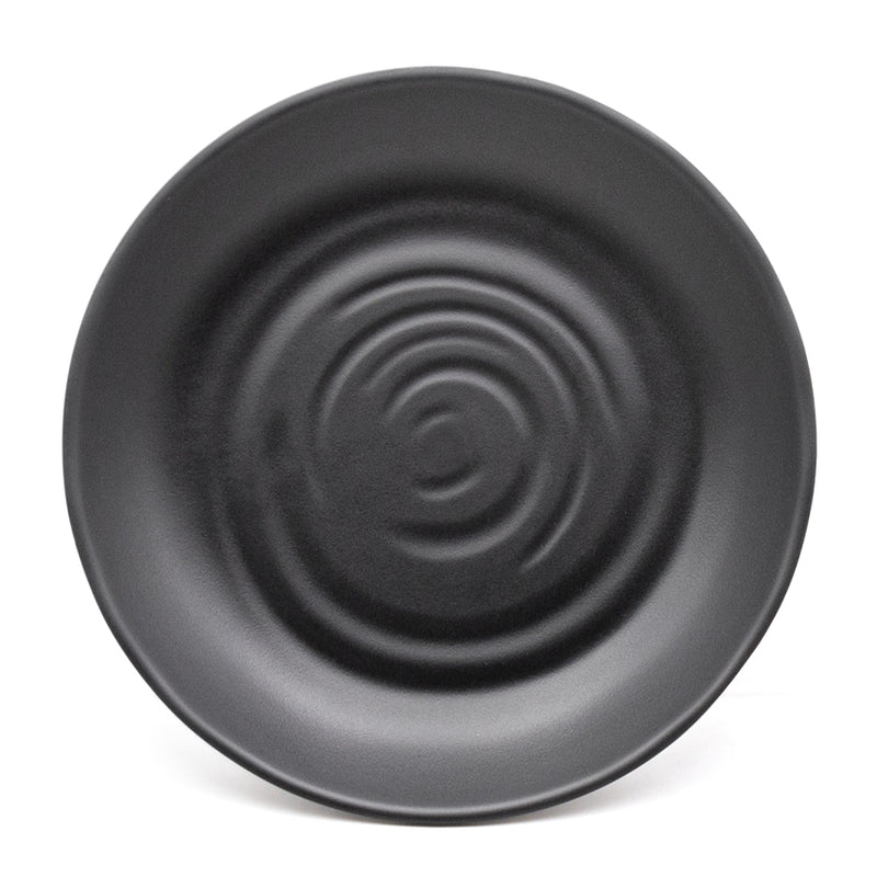 Top view showing the black plate's concentric molded ripples and gently curved rim