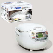 Zojirushi NS-ZCC10-WZ Premium White Neuro Fuzzy rice cooker with a hinged lid, colored front LCD controls, side carrying handle and its NS-ZCC10 carton.